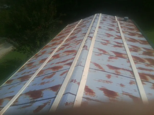 Rusted metal roof panels with new wood purlins before replacement — Storm Damage Roof Repair in Franklin Furnace by Roofing Brothers